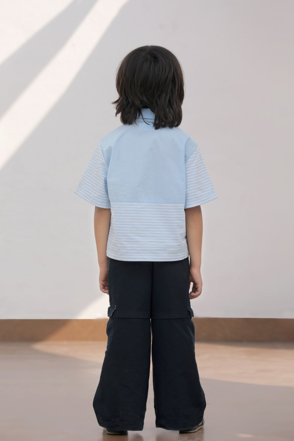 Luxe & Hardy Ash Blue Panelled Shirt – back view of light blue short sleeve panelled texture boys shirt with navy blue wide leg pants, kids ethnic casual party wear shirt, back panel detail