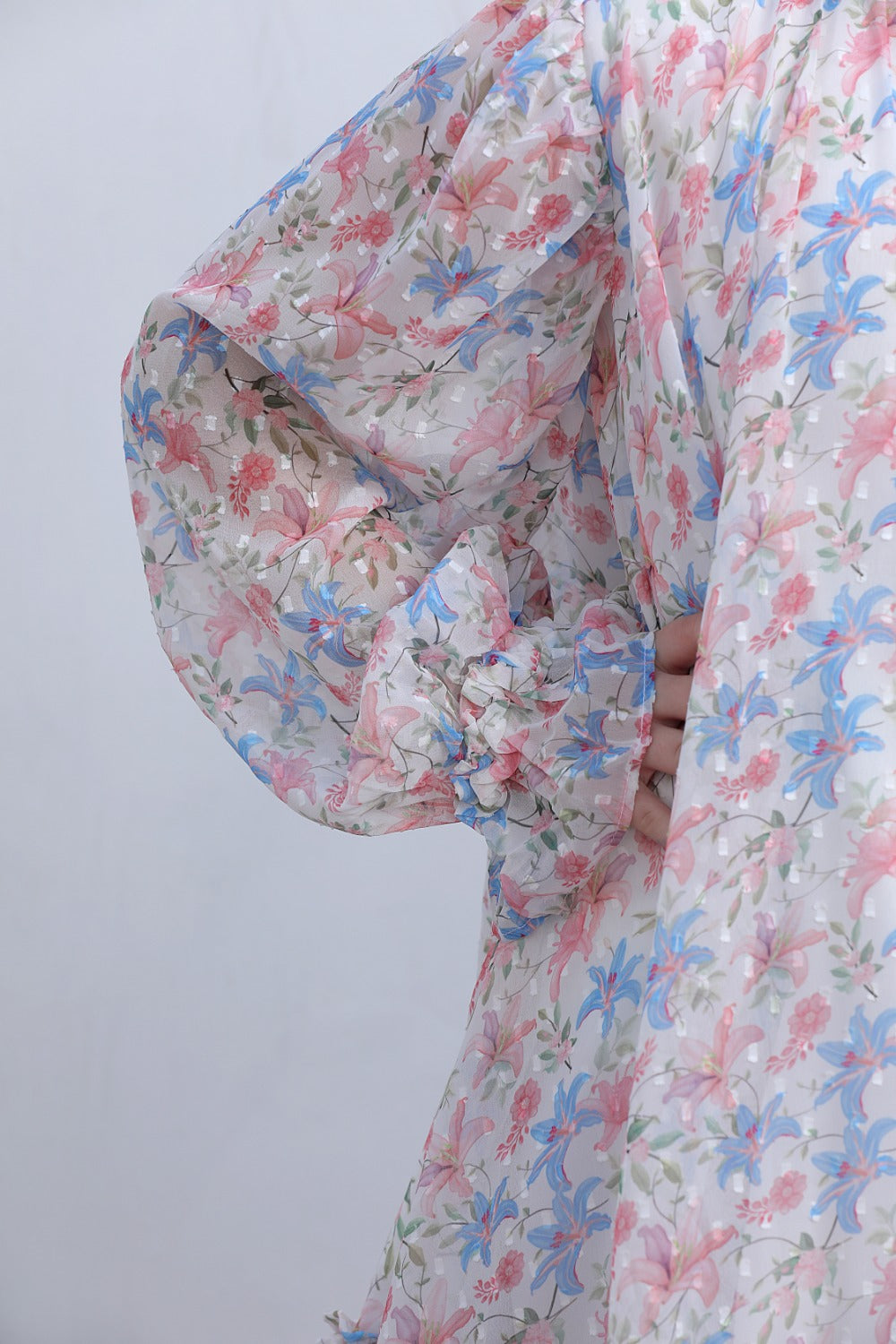 Flat lay front view of white floral tiered midi dress with long sleeves