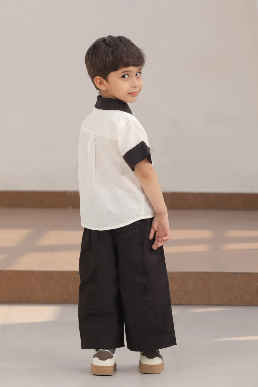 Luxe & Hardy Everwood Ensemble – three-quarter view of white black stripe shirt and black wide leg palazzo pants, toddler boys co ord set, kids festive party wear ethnic outfit
