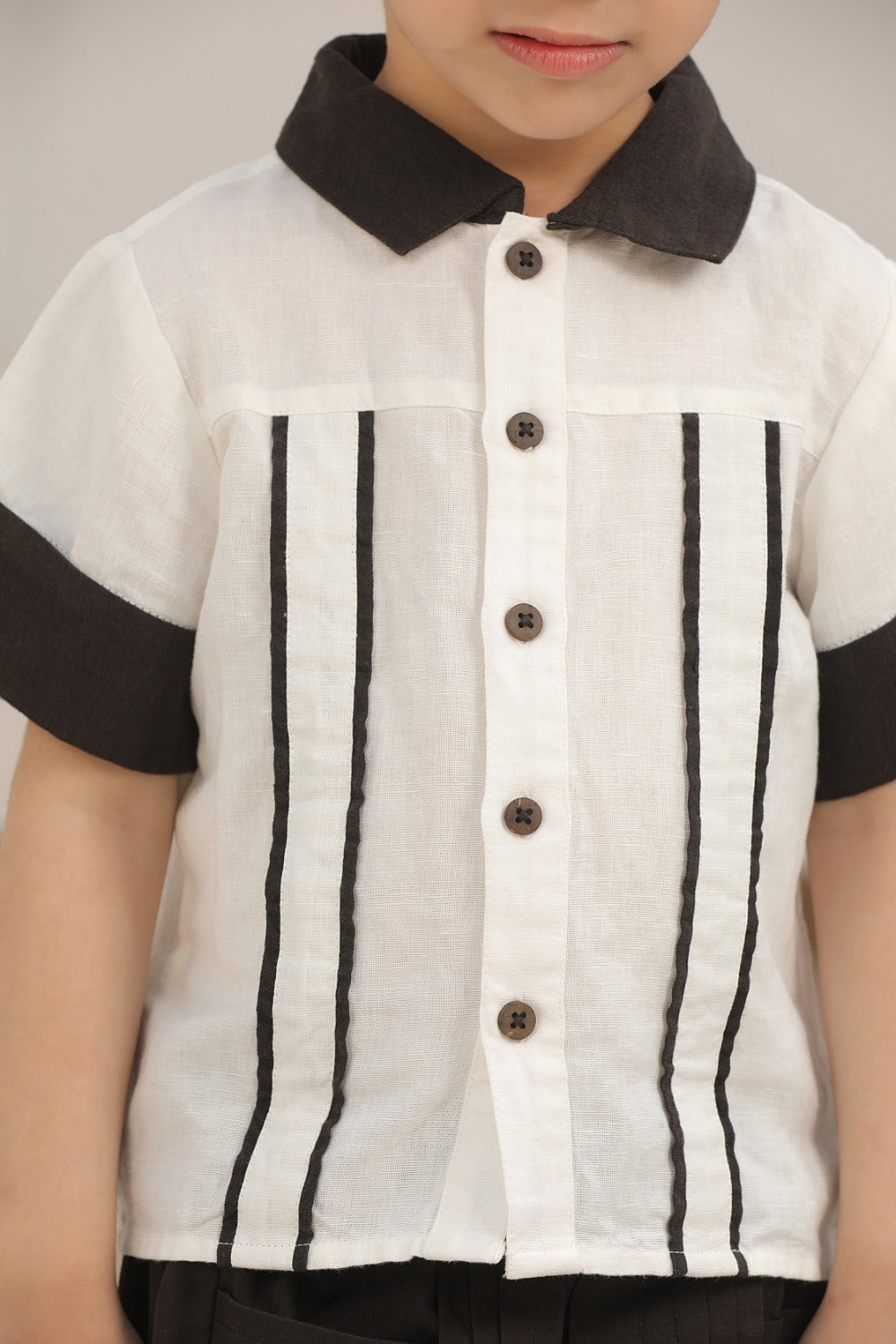 Luxe & Hardy Everwood Ensemble – close-up front view of white black pinstripe short sleeve boys shirt with black button detail, kids ethnic party wear co ord set, toddler festive outfit