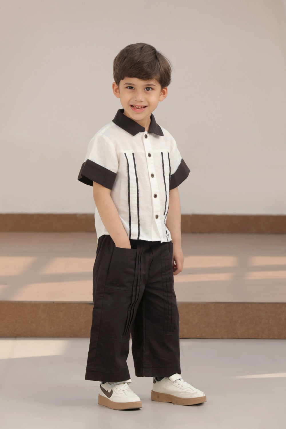 Luxe & Hardy Everwood Ensemble – side profile full length view of white black pinstripe boys shirt and black wide leg pants co ord set, toddler kids ethnic party wear outfit