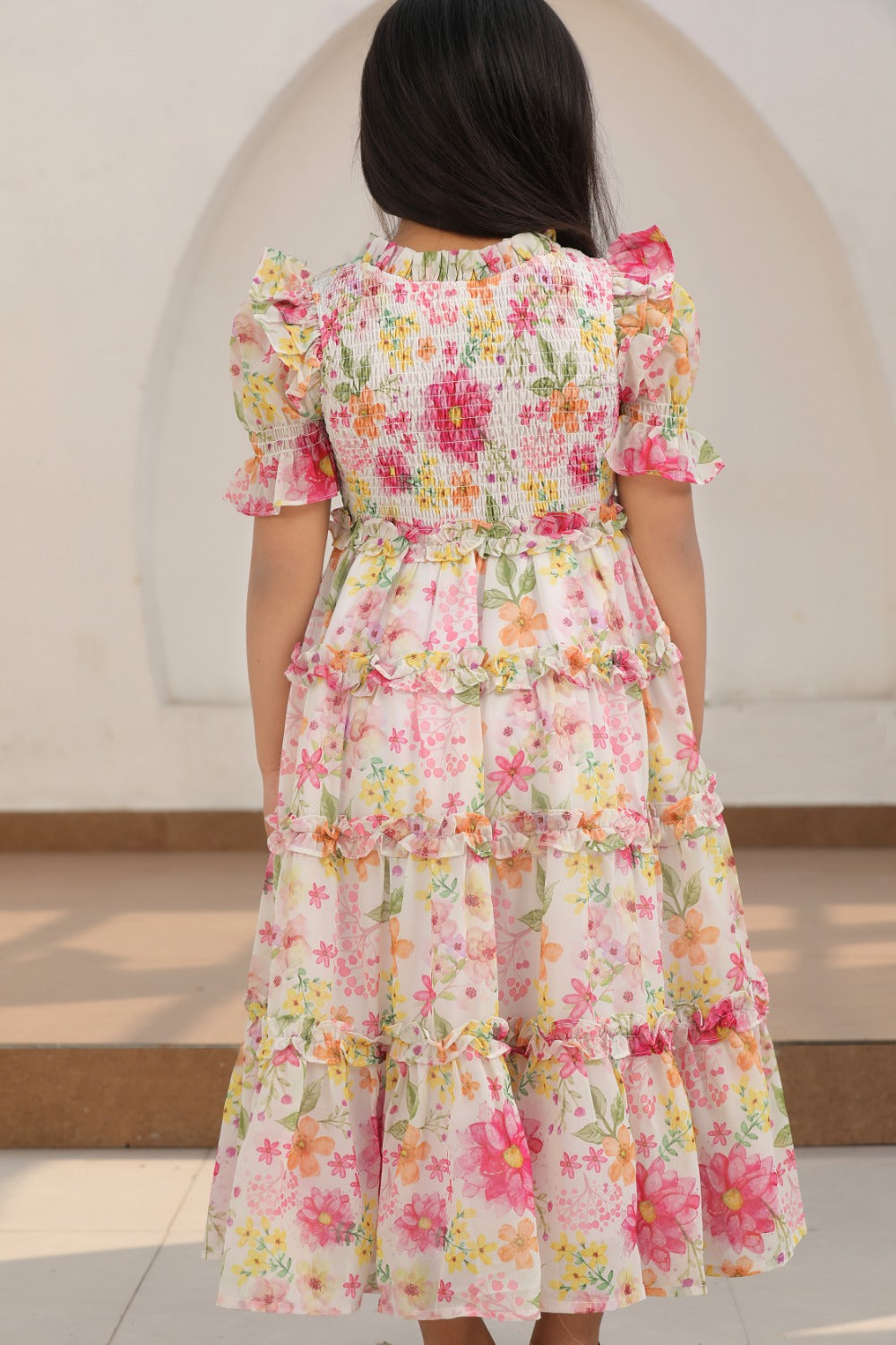 Close-up of smocked neckline and pink floral print on dress bodice