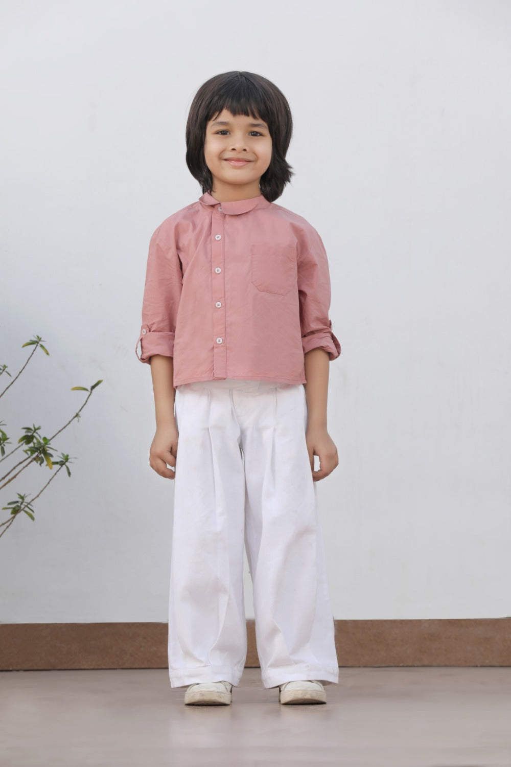 Luxe & Hardy Henry Asymmetrical Shirt – back view of dusty pink long sleeve mandarin collar asymmetrical linen boys shirt with white wide leg pants, kids ethnic casual party wear shirt