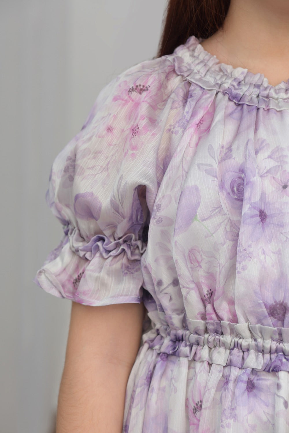Close-up of smocked elastic waistband on lavender floral dress