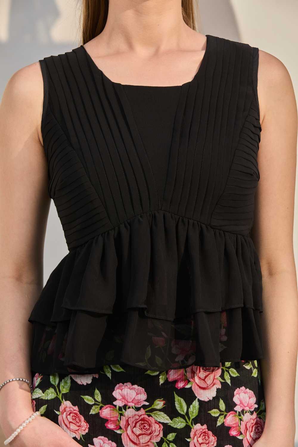 Luxe & Hardy Sera Rose Co-ord Set – close-up of black sleeveless peplum top detail, black top co ord set women, fitted bodice with ruffle peplum hem and keyhole back