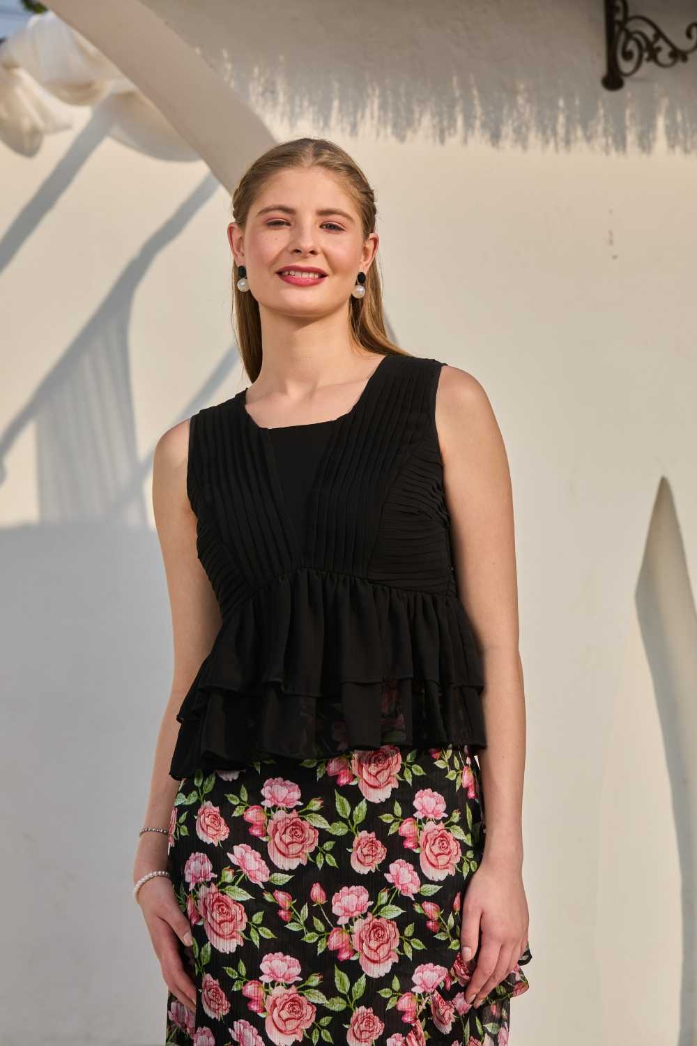 Luxe & Hardy Sera Rose Co-ord Set – full length standing pose, black floral printed co ord set for women, sleeveless peplum crop top and slit hi low maxi skirt