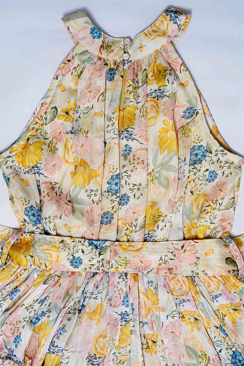 Close-up of pastel floral print fabric and tiered skirt detail