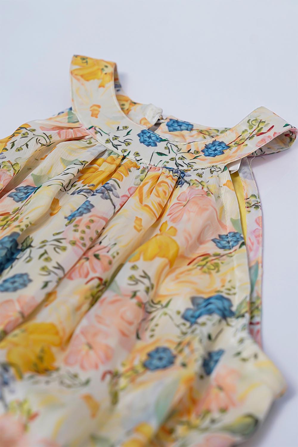 Close-up of halter neckline and tie detail on floral dress