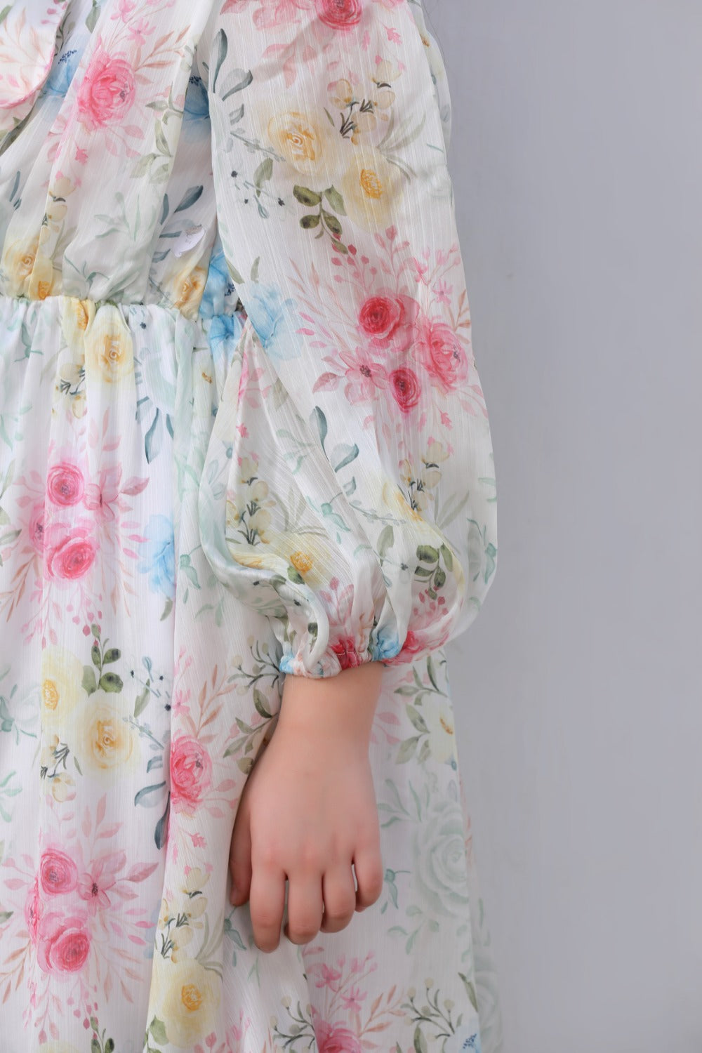 Close-up of white chiffon fabric with pink and yellow floral print