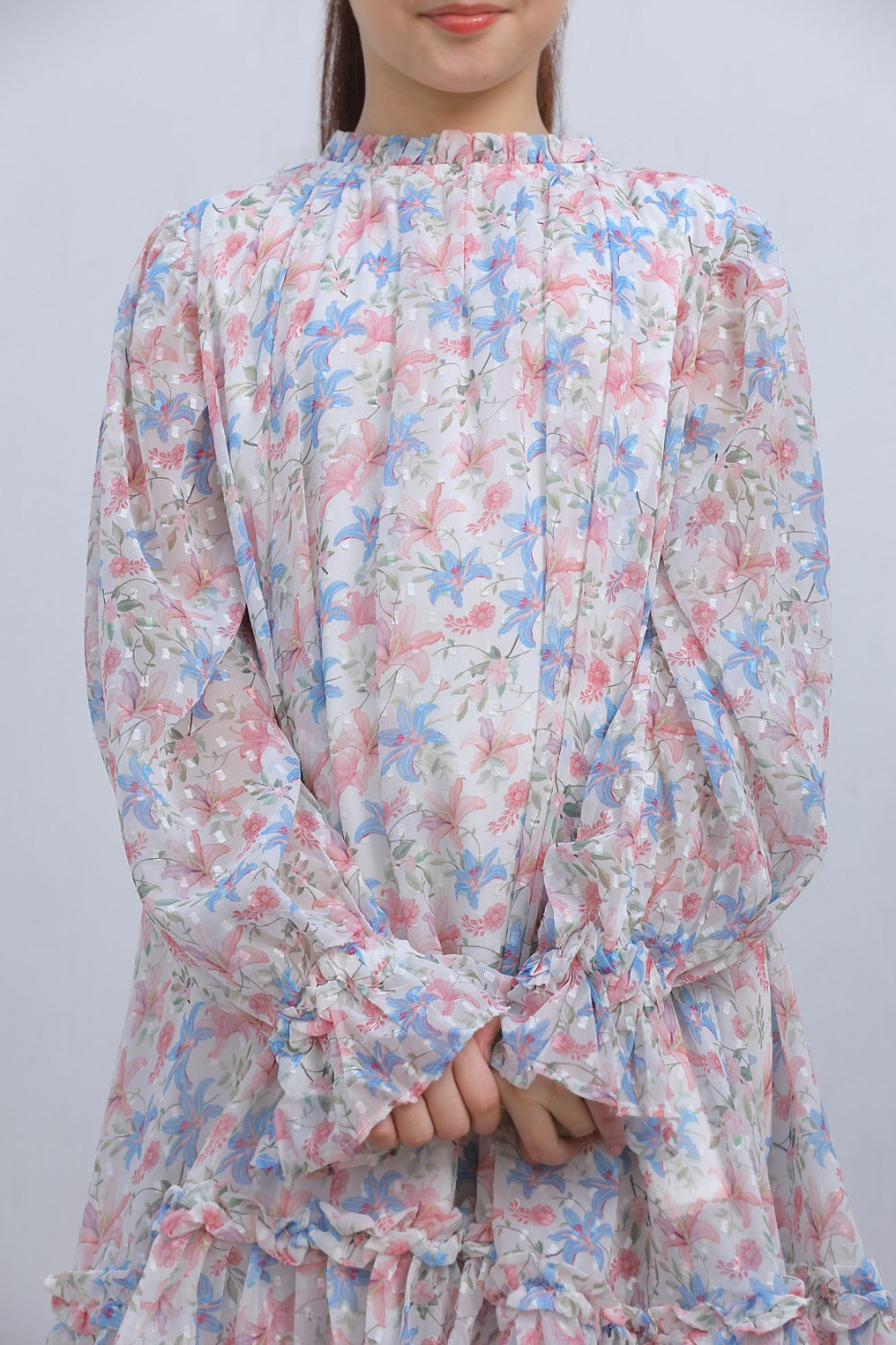 Close-up of pink and blue floral print on white chiffon fabric
