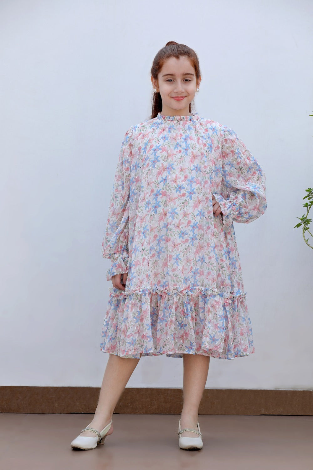 Girl in white floral long-sleeve tiered midi dress, full-length front view