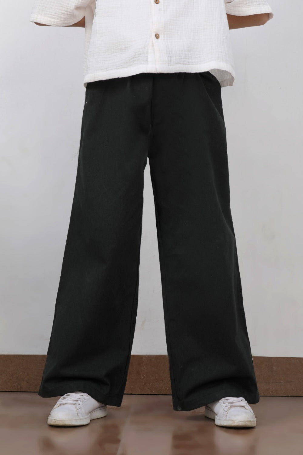 Luxe & Hardy Charles Relaxed Pants – side profile full length view of black wide leg relaxed linen boys pants, kids ethnic casual bottom wear, styled with white shirt and white sneakers