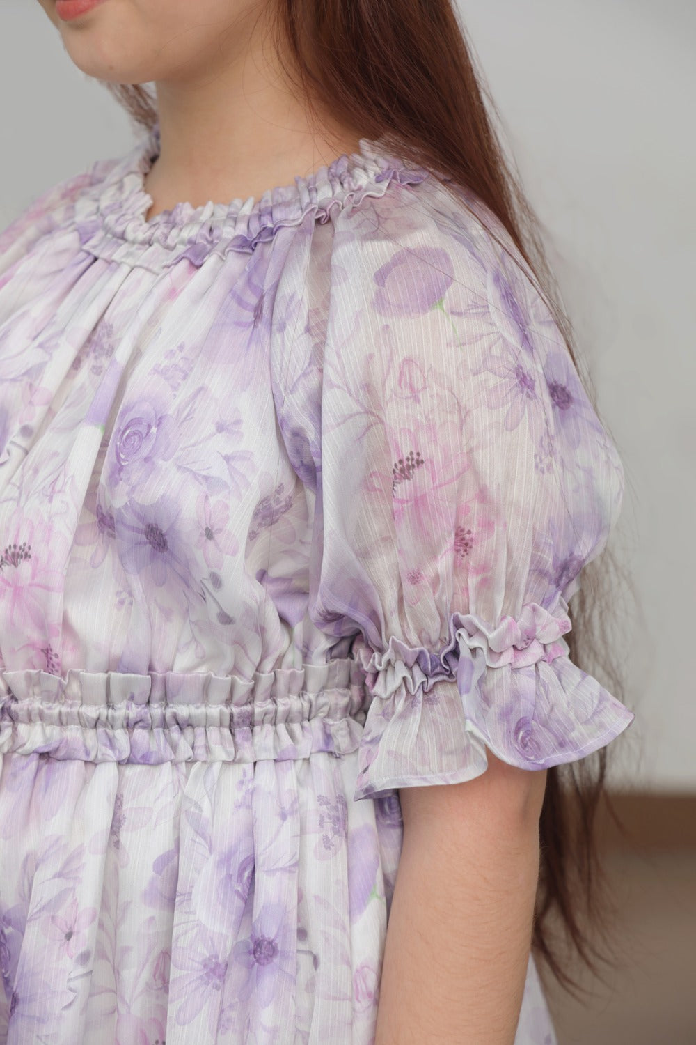 Close-up of purple watercolour floral print and ruffle hem on midi skirt