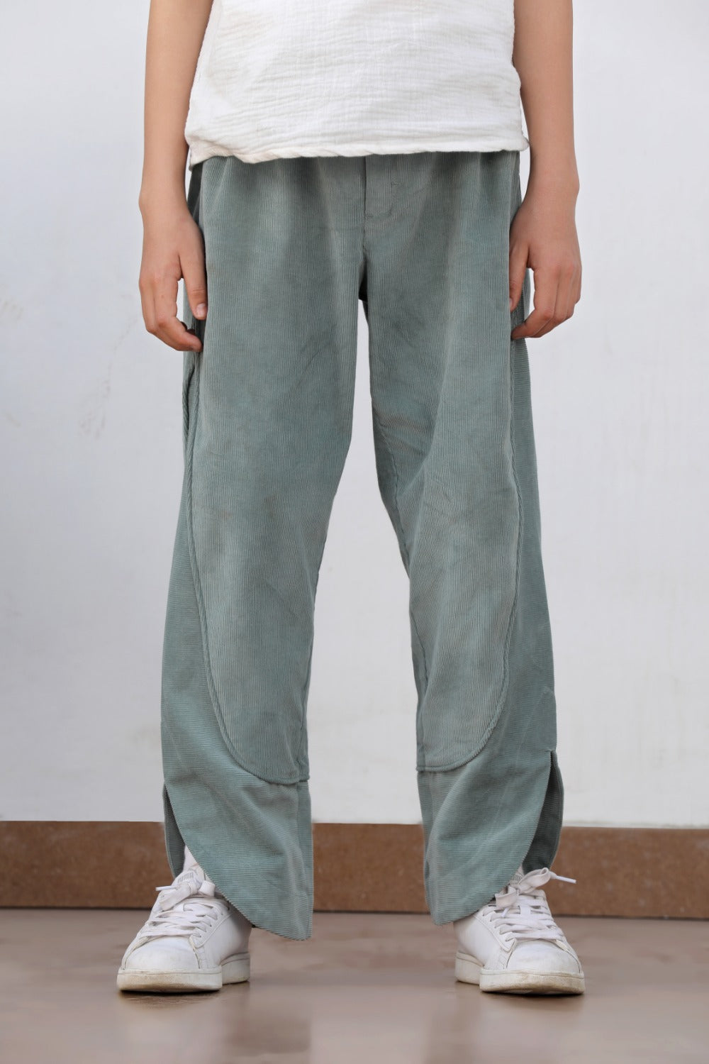 Luxe & Hardy Milo Textured Pant – close-up front view of sage green textured wide leg relaxed fit boys pants, kids ethnic casual bottom wear, styled with white sneakers, indoor setting