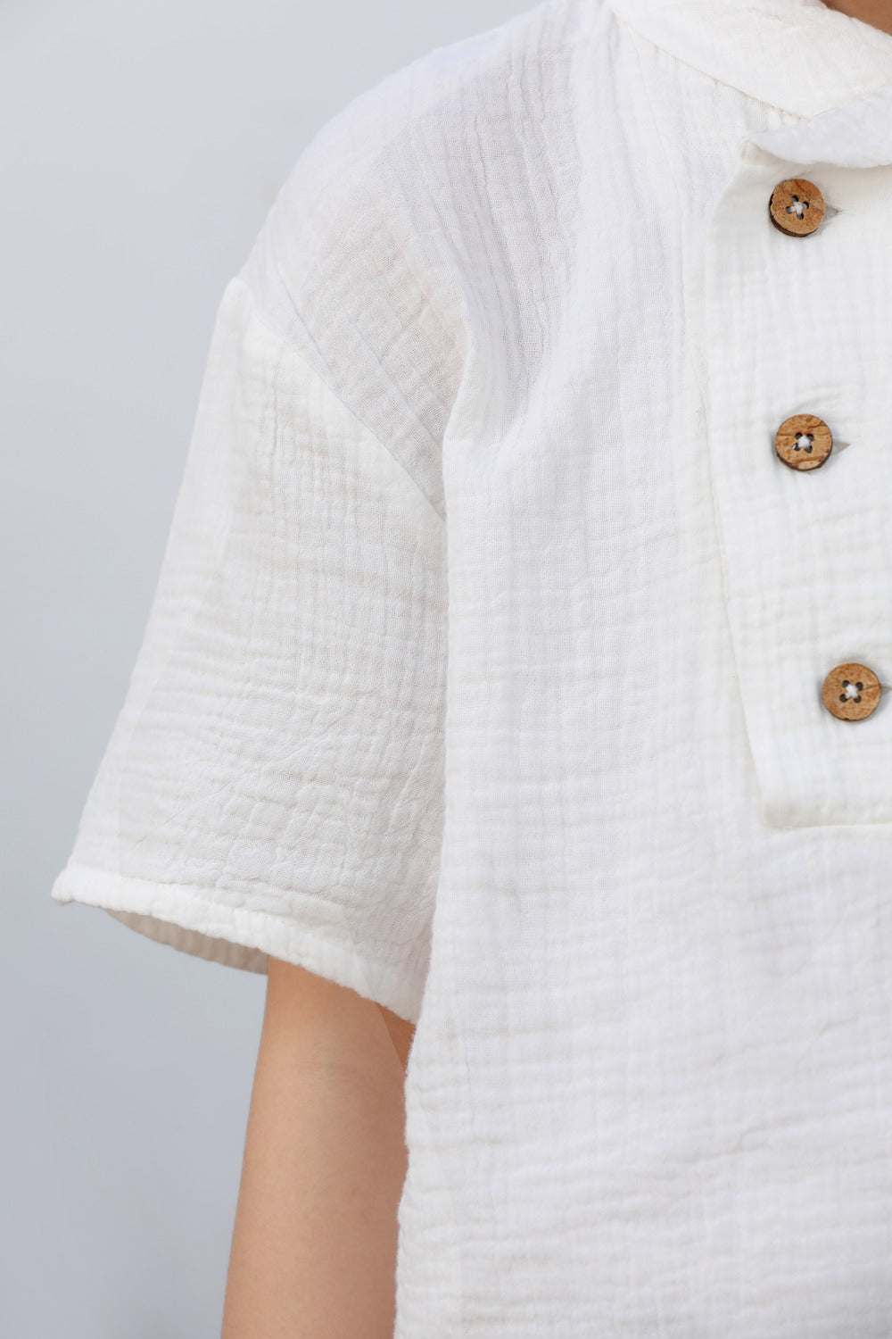 Luxe & Hardy Milo Textured Tee – close-up of white textured linen fabric and double wooden button placket detail, boys ethnic casual shirt, premium breathable linen weave and button detail