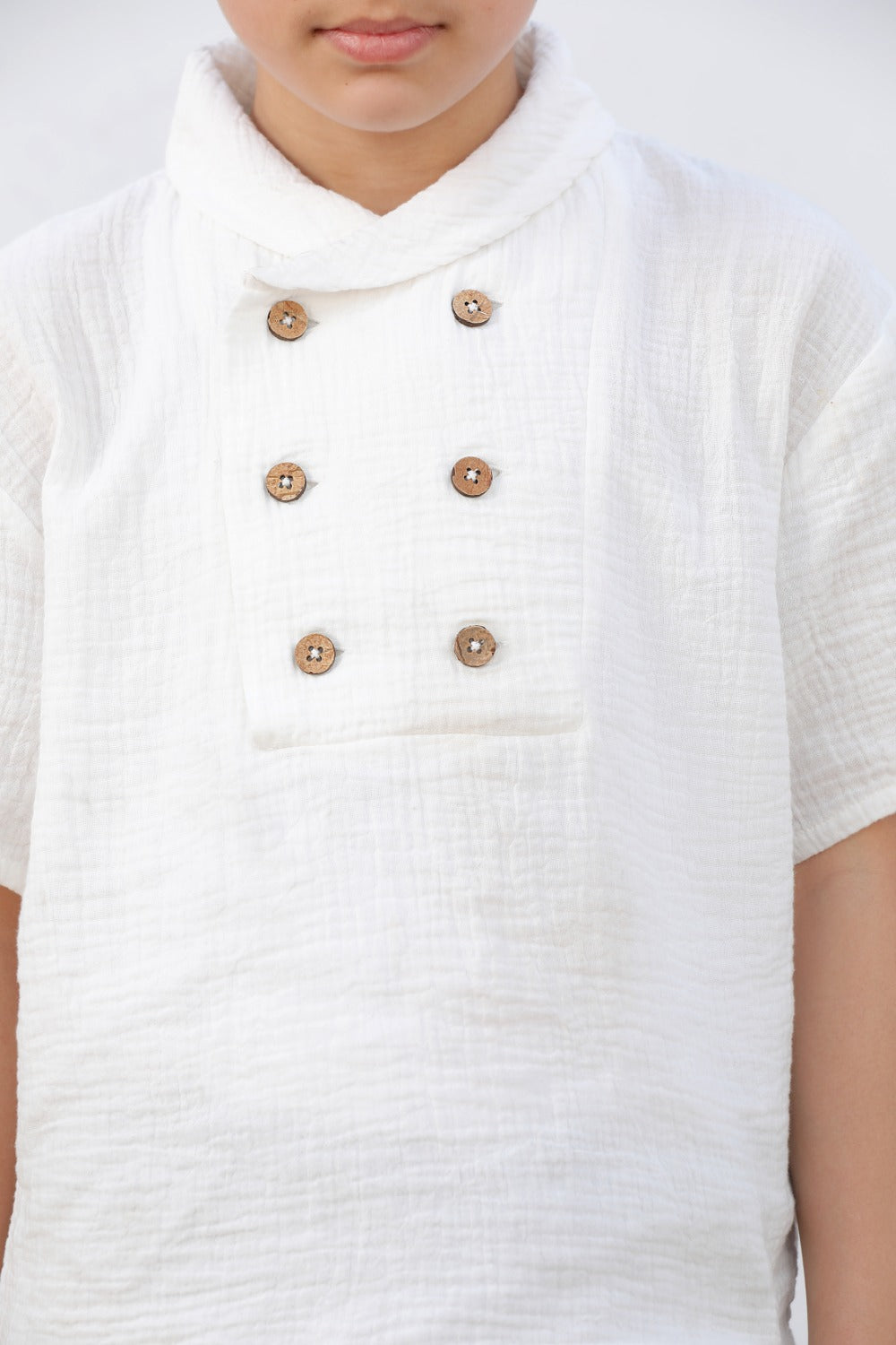 Luxe & Hardy Milo Textured Tee – close-up front view of white textured linen boys shirt with double wooden button placket detail, kids ethnic casual party wear shirt, premium button and fabric detail