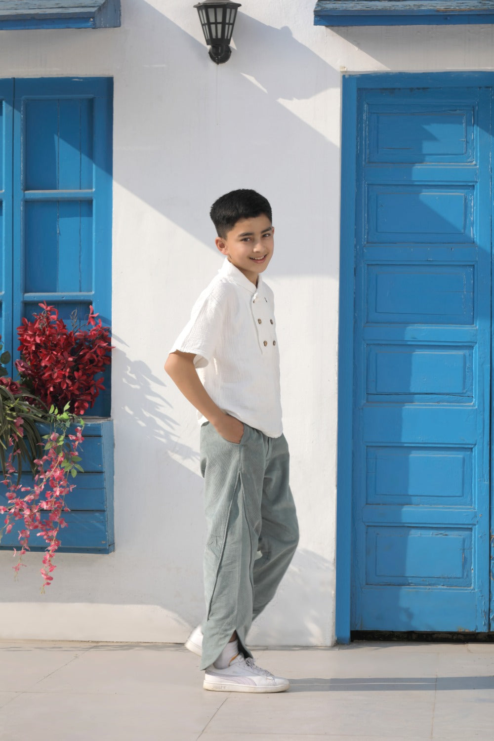 Luxe & Hardy Milo Textured Tee – side profile full length view of white textured linen double button boys shirt with sage green relaxed pants, kids ethnic casual festive shirt