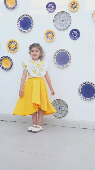 Girl in white floral top and yellow high-low skirt, full outfit — video preview