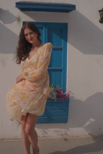Luxe & Hardy Blair Dress – video of yellow floral long sleeve v neck tiered mini dress for women in motion, play to see full short dress styling outdoors