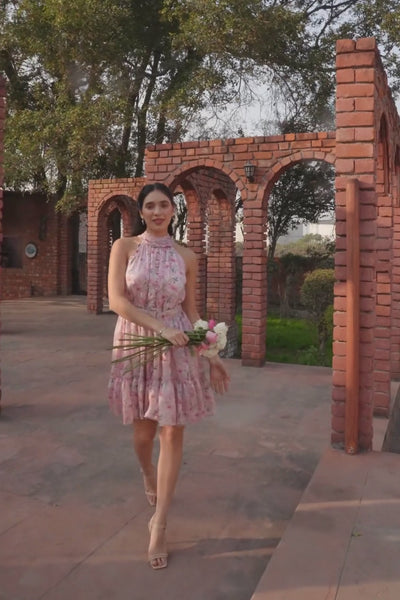 Luxe & Hardy Iris Halter Dress in Lavender – video thumbnail showing lavender floral tiered halter mini dress styled outdoors, play to see full dress in motion
